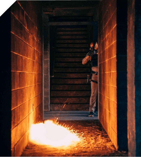 A fiery explosion in a dark industrial corridor.